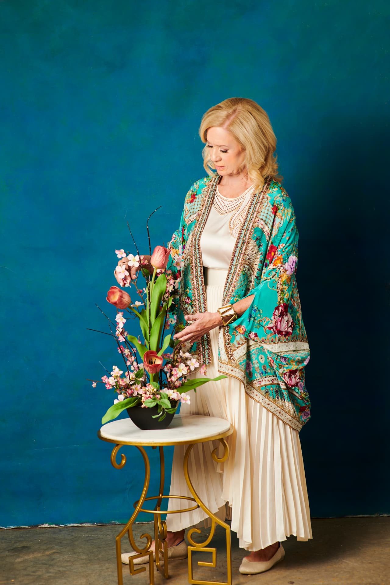 Jennifer arranging spring flowers in a turquoise silk kimono